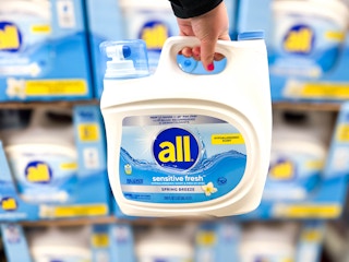 hand holding a jug of all detergent