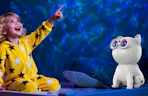 a cat galaxy projector next to a little kid