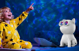 a cat galaxy projector next to a little kid