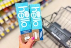 hand holding hello toothpaste in walgreens