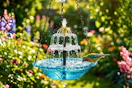 Lifestyle image of a hanging solar bird bath water fountain