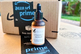 a bottle of face serum next to an Amazon box