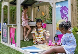 children playing with Barbies and the outdoor playhouse