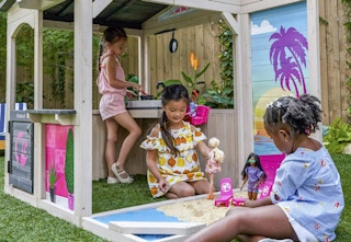 children playing with Barbies and the outdoor playhouse