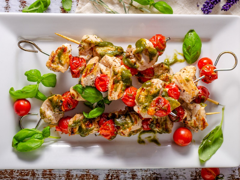 Chicken shish kebab with fresh basil pesto, tomatoes and garlic