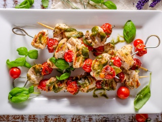 Chicken shish kebab with fresh basil pesto, tomatoes and garlic