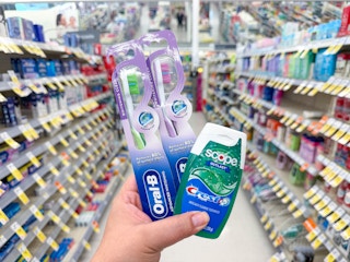 hand holding crest and oral-b items in walgreens