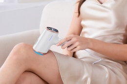 a woman using a laser hair removal device
