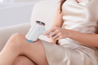 a woman using a laser hair removal device