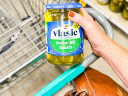 hand holding a jar of vlasic pickes