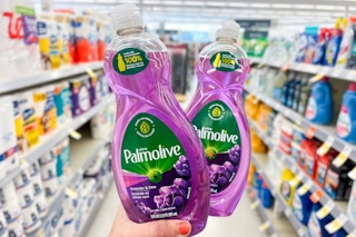 hand holding two bottles of palmolive