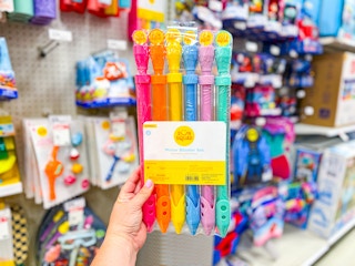 hand holding a sun squad water blaster 6-pack at target