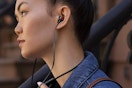 a woman wearing beats flex earbuds