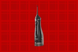 a water flosser on a red background