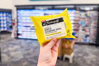 person holding a package of neutrogena sun makeup remover wipes