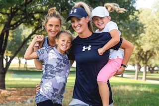 a mother and girls wearing under armour outside in a park 