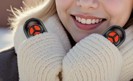 a person holding hand warmers with gloves