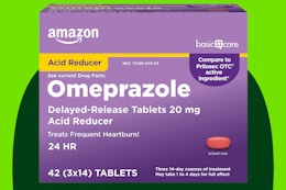 Omeprazole tablets on a green background.