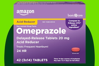 Omeprazole tablets on a green background.