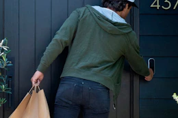 someone using an Arlo video doorbell