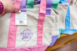 hand holding trader joes mini canvas tote bags