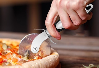 pizza wheel cutting pizza