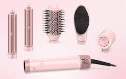 a pink hot air styler and attachments
