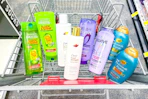 garnier, dove, loreal, and ogx shampoo in a cart