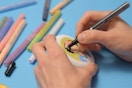 Hands coloring using paint pens.