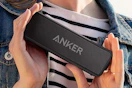 Woman holding the Anker Soundcore 2 Portable Bluetooth Speaker
