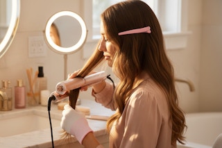 a woman using a hair straightener