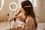 a woman using a hair straightener