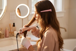 a woman using a hair straightener