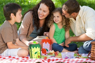 Family enjoy picnic outdoors