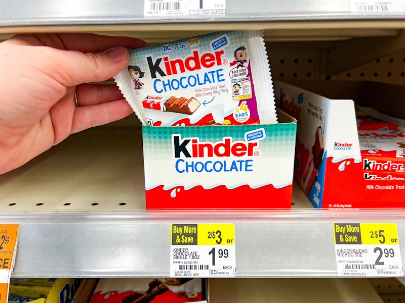 person grabbing a kinder chocolate bar from the display box