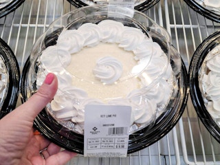 hand grabbing a key lime pie