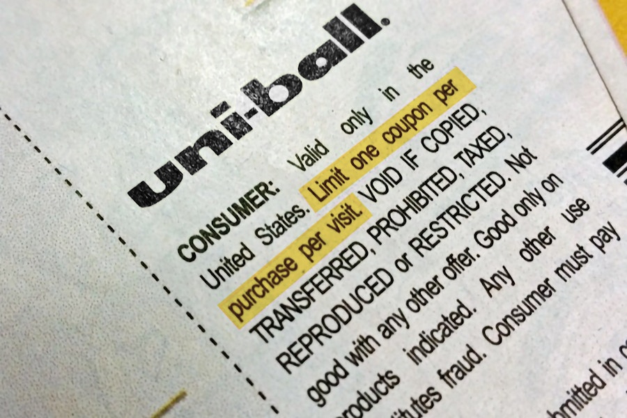 A close up on a Uniball coupon showing the fine print highlighted which says, "Limit one coupon per purchase per visit