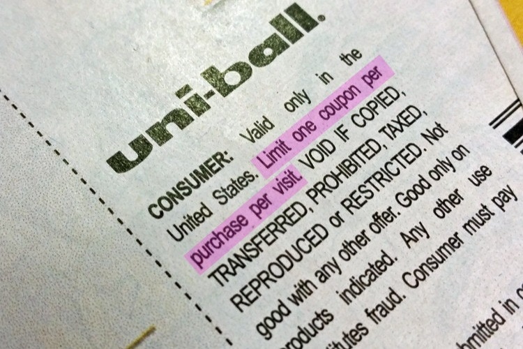 A close up on a Uniball coupon showing the fine print highlighted which says, 