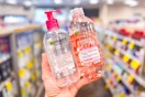 person holding up bottles of garnier micellar water and cleanser in an aisle
