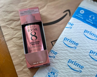 a bottle of l'oreal elvive 8 second wonder water with an amazon package