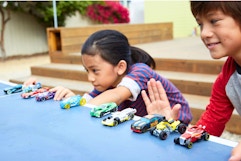 Lifestyle image of kids playing with hot wheel cars