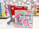 barbie dreamhouse sitting in front a parked target cart