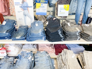 a display of women jeans spread across on tables. the jeans of of different shades