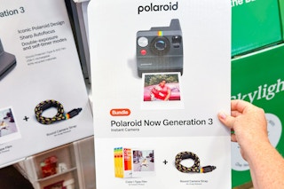 hand holding polaroid instant camera bundle at costco