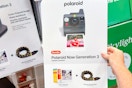 hand holding polaroid instant camera bundle at costco