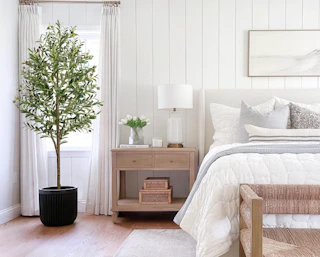 an artificial olive tree in a room