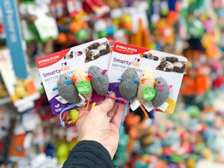 A hand holding SmartKat cat toys