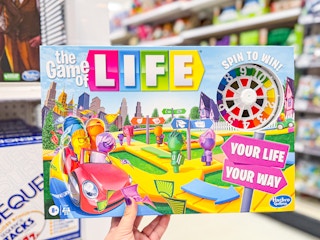 hand holding the game of life in front of games at target