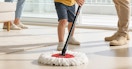 a person mopping the floor with a spin mop