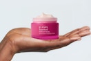 hand holding up Elemis Superfood Midnight Facial container